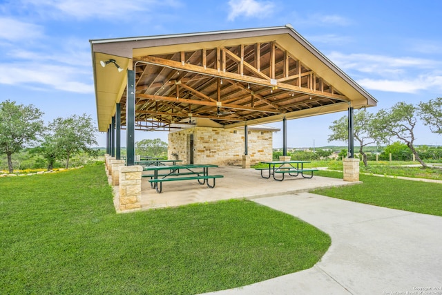 view of property's community with a lawn and a patio area