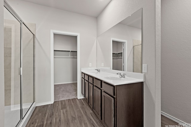 bathroom featuring vanity, a shower with shower door, and hardwood / wood-style flooring