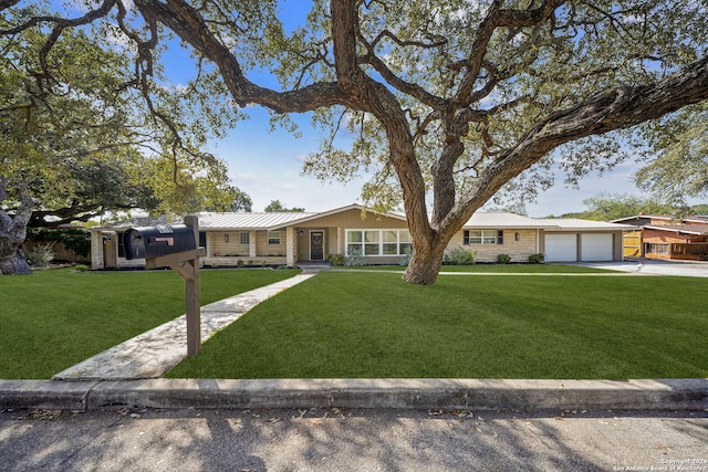 ranch-style home with a garage and a front yard