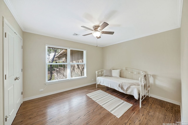 bedroom with hardwood / wood-style flooring, ceiling fan, and crown molding