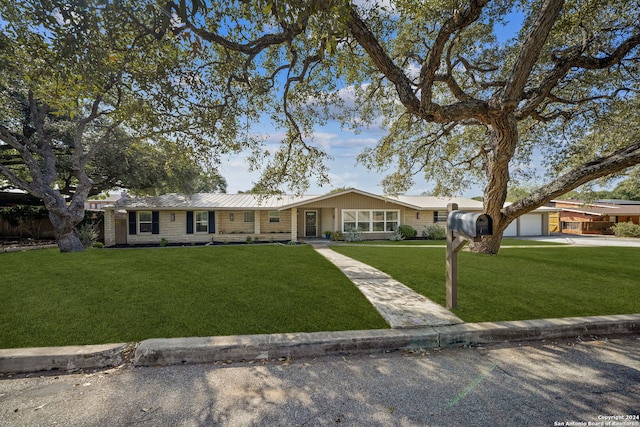 single story home with an outbuilding and a front yard