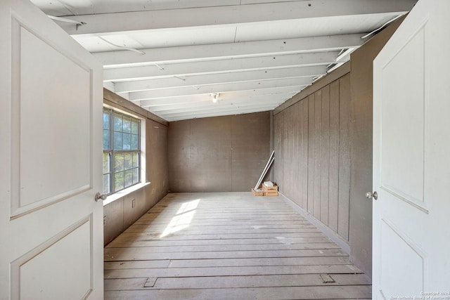 interior space featuring light wood-type flooring and wood walls