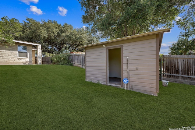 view of outbuilding with a yard