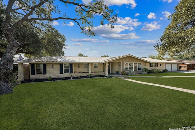 single story home with a garage and a front lawn