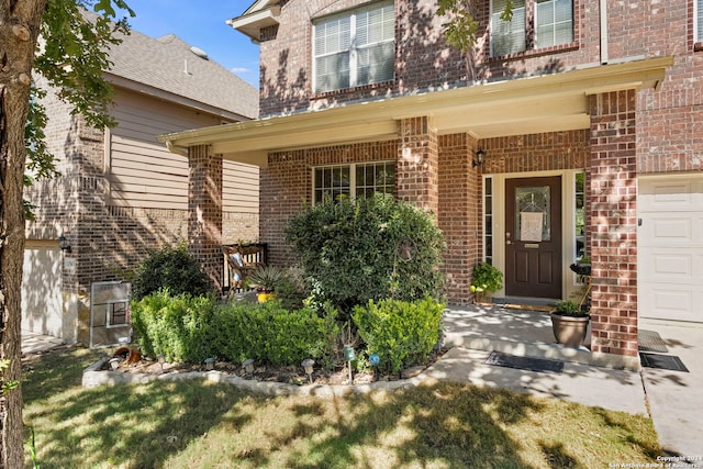 doorway to property with a porch and a garage