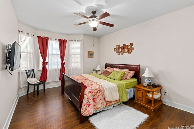 bedroom with dark hardwood / wood-style flooring and ceiling fan