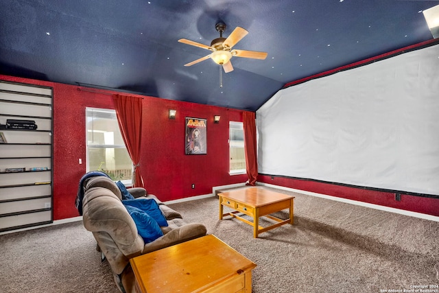 carpeted cinema room with a wealth of natural light, ceiling fan, and vaulted ceiling