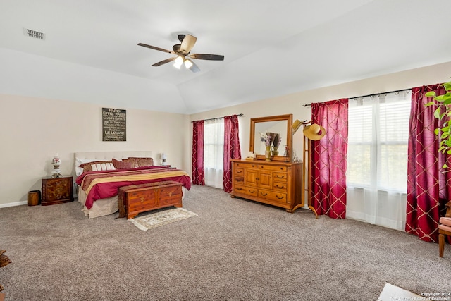 carpeted bedroom with multiple windows, vaulted ceiling, and ceiling fan