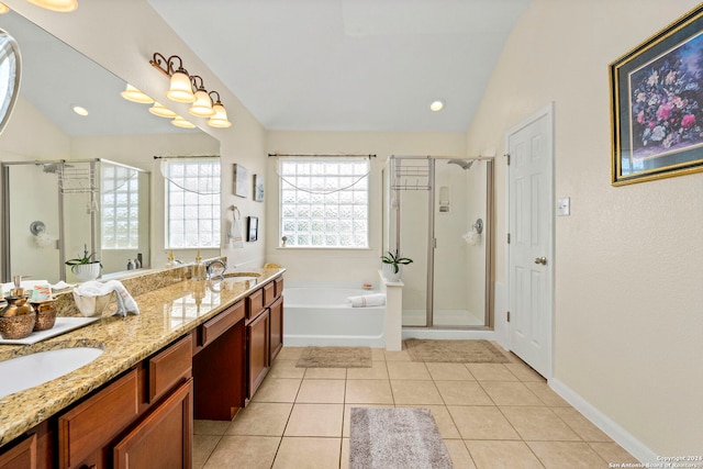 bathroom with tile patterned flooring, lofted ceiling, separate shower and tub, and vanity