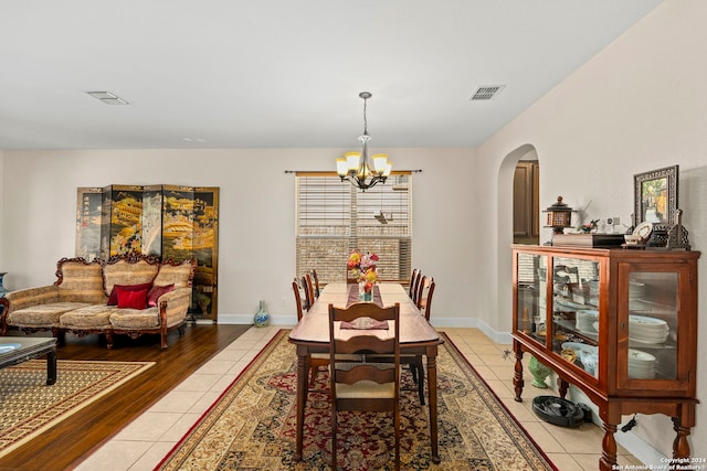 dining room featuring a chandelier and light hardwood / wood-style flooring