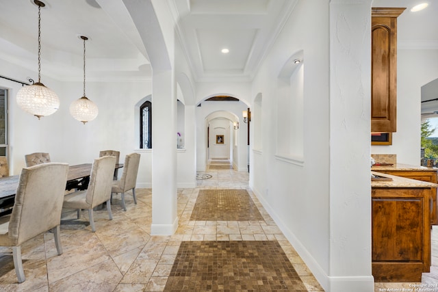 hallway featuring an inviting chandelier and ornamental molding