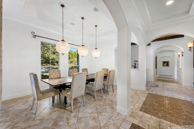 dining area featuring a tray ceiling and crown molding