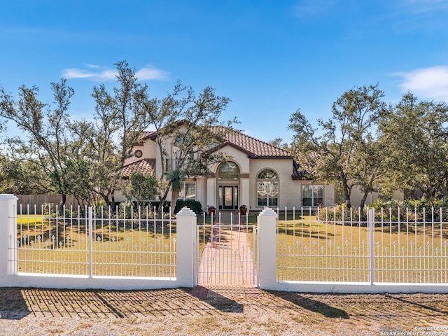 mediterranean / spanish home with a front yard