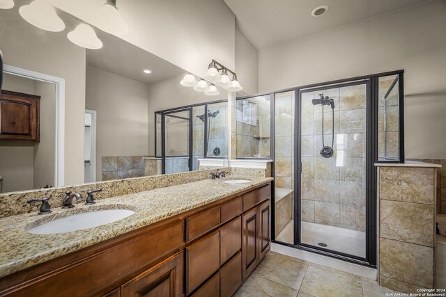 bathroom with vanity, tile patterned floors, and an enclosed shower