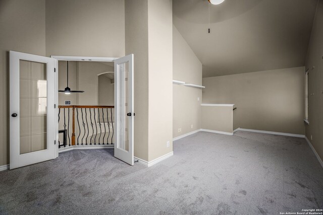 additional living space featuring vaulted ceiling, french doors, and carpet floors