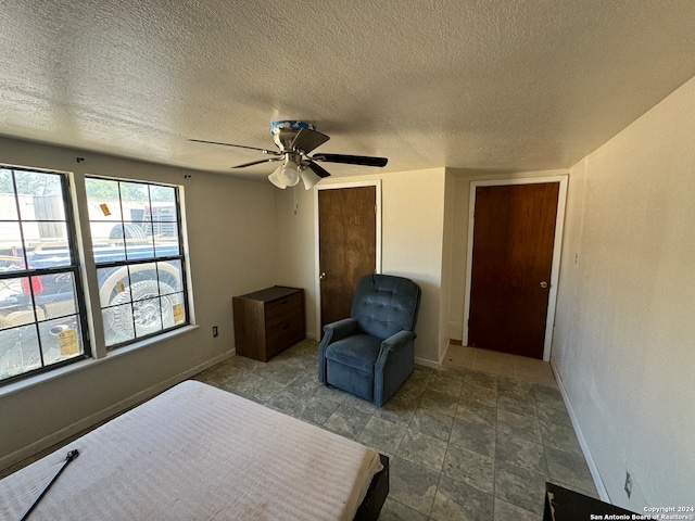 bedroom featuring a textured ceiling and ceiling fan