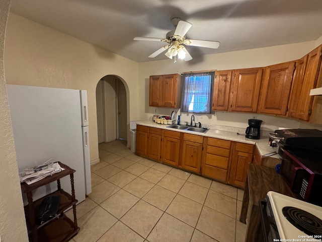 kitchen with white appliances, sink, light tile patterned floors, and ceiling fan