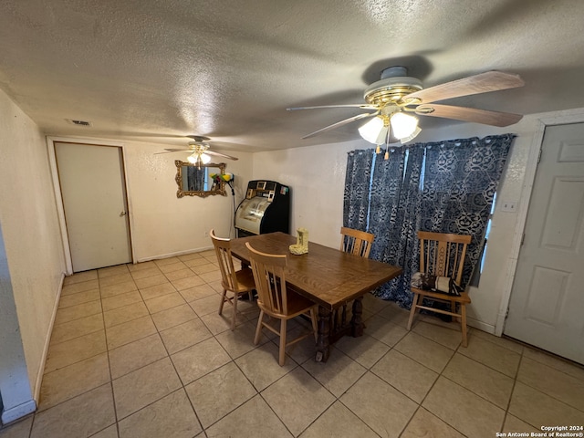 dining space featuring a textured ceiling, ceiling fan, and light tile patterned flooring