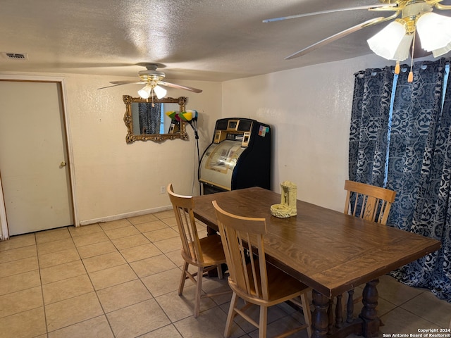 dining space featuring light tile patterned flooring, a textured ceiling, and ceiling fan