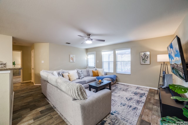 living room with dark hardwood / wood-style flooring and ceiling fan