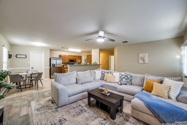 living room with light wood-type flooring and ceiling fan