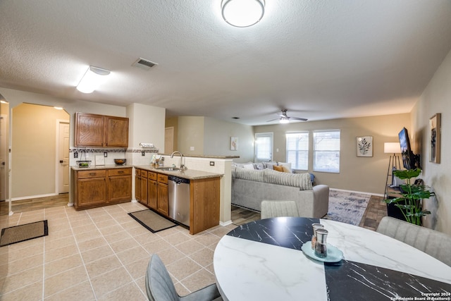 12750 Rambling Rose, San Antonio, TX 78253 - kitchen with dishwasher, a sink, open floor plan, a peninsula, and brown cabinets