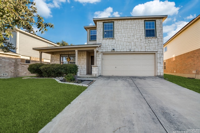 view of front property with a garage and a front lawn