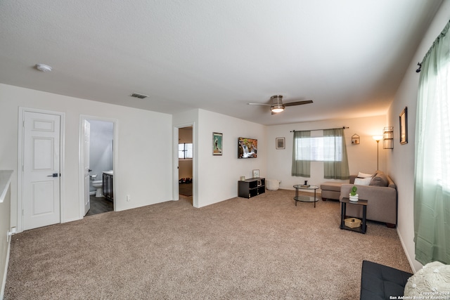 living room featuring ceiling fan and carpet floors