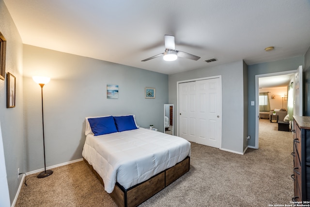 carpeted bedroom with a closet and ceiling fan