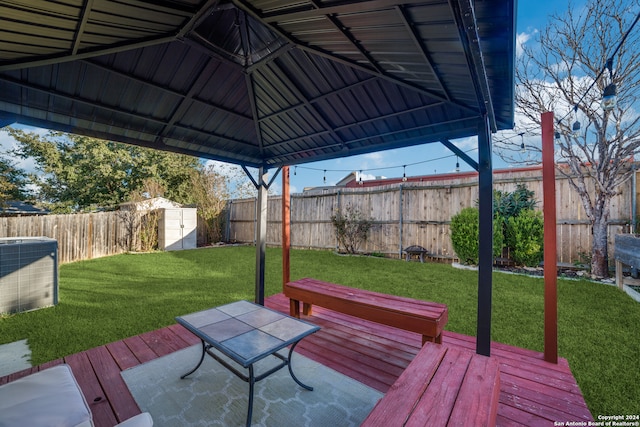 wooden terrace featuring a yard and a gazebo