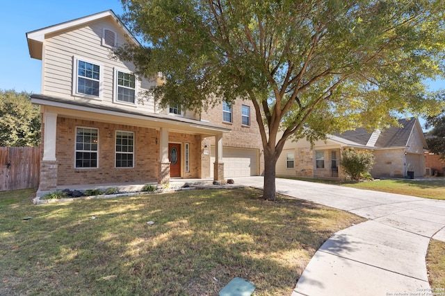 view of front facade featuring covered porch, a garage, and a front yard