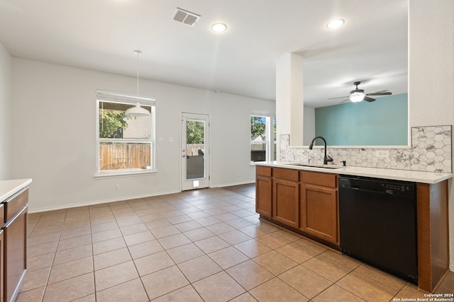 kitchen with black dishwasher, hanging light fixtures, a healthy amount of sunlight, and sink