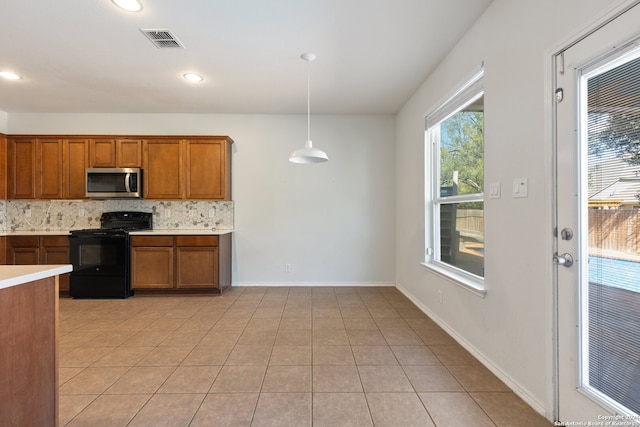 kitchen featuring a wealth of natural light, light tile patterned floors, decorative light fixtures, and black range with electric cooktop