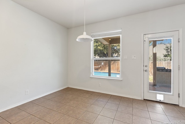 unfurnished dining area featuring light tile patterned floors and a healthy amount of sunlight