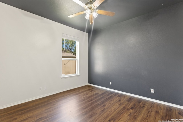 unfurnished room featuring ceiling fan and dark hardwood / wood-style floors