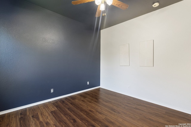 spare room featuring dark hardwood / wood-style floors and ceiling fan