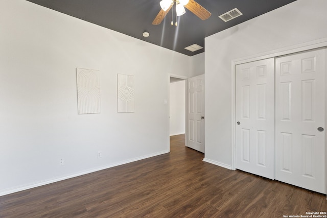 unfurnished bedroom with a closet, dark hardwood / wood-style floors, and ceiling fan