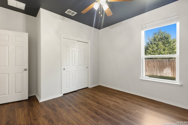 unfurnished bedroom featuring dark hardwood / wood-style flooring, a closet, and ceiling fan