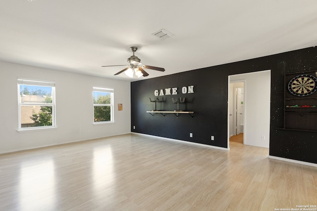 unfurnished living room with light wood-type flooring and ceiling fan