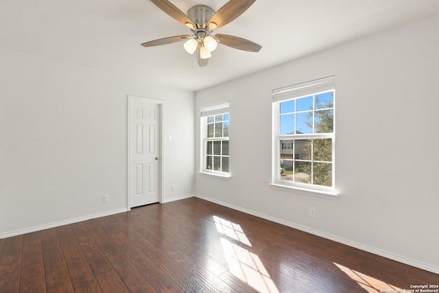 empty room with ceiling fan and dark wood-type flooring