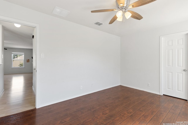 unfurnished room featuring ceiling fan and dark wood-type flooring