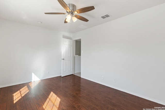 spare room featuring ceiling fan and dark wood-type flooring