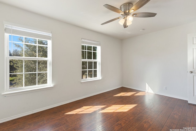 spare room with plenty of natural light, dark hardwood / wood-style floors, and ceiling fan