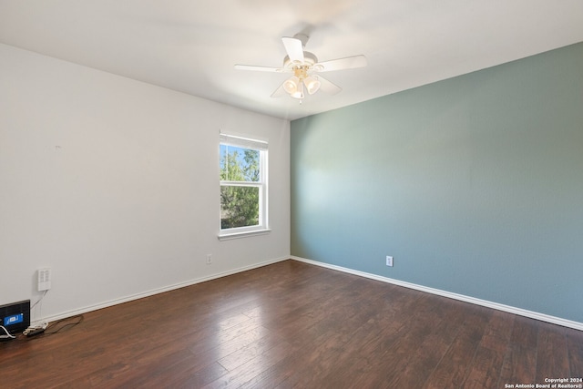 unfurnished room featuring ceiling fan and dark hardwood / wood-style flooring