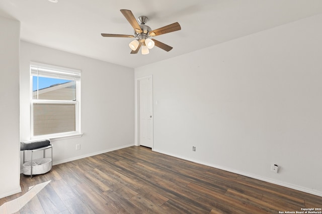 spare room featuring ceiling fan and dark hardwood / wood-style flooring