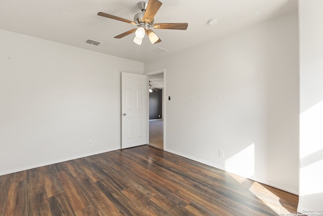 unfurnished room with ceiling fan and dark hardwood / wood-style flooring