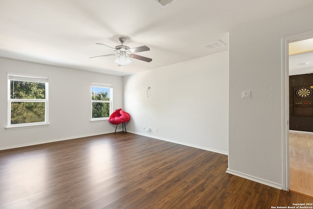 spare room with ceiling fan and dark wood-type flooring