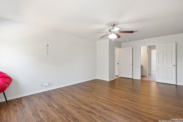 spare room featuring ceiling fan and dark wood-type flooring