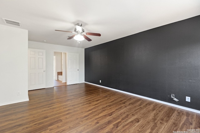 unfurnished room featuring dark hardwood / wood-style floors and ceiling fan