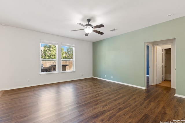 spare room featuring ceiling fan and dark wood-type flooring